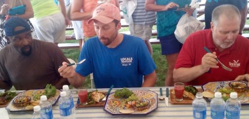Eduardo Wins One for Ocracoke Judges Rev. Joyner, Jack Thigpen, and Ryan Speckman dig in!